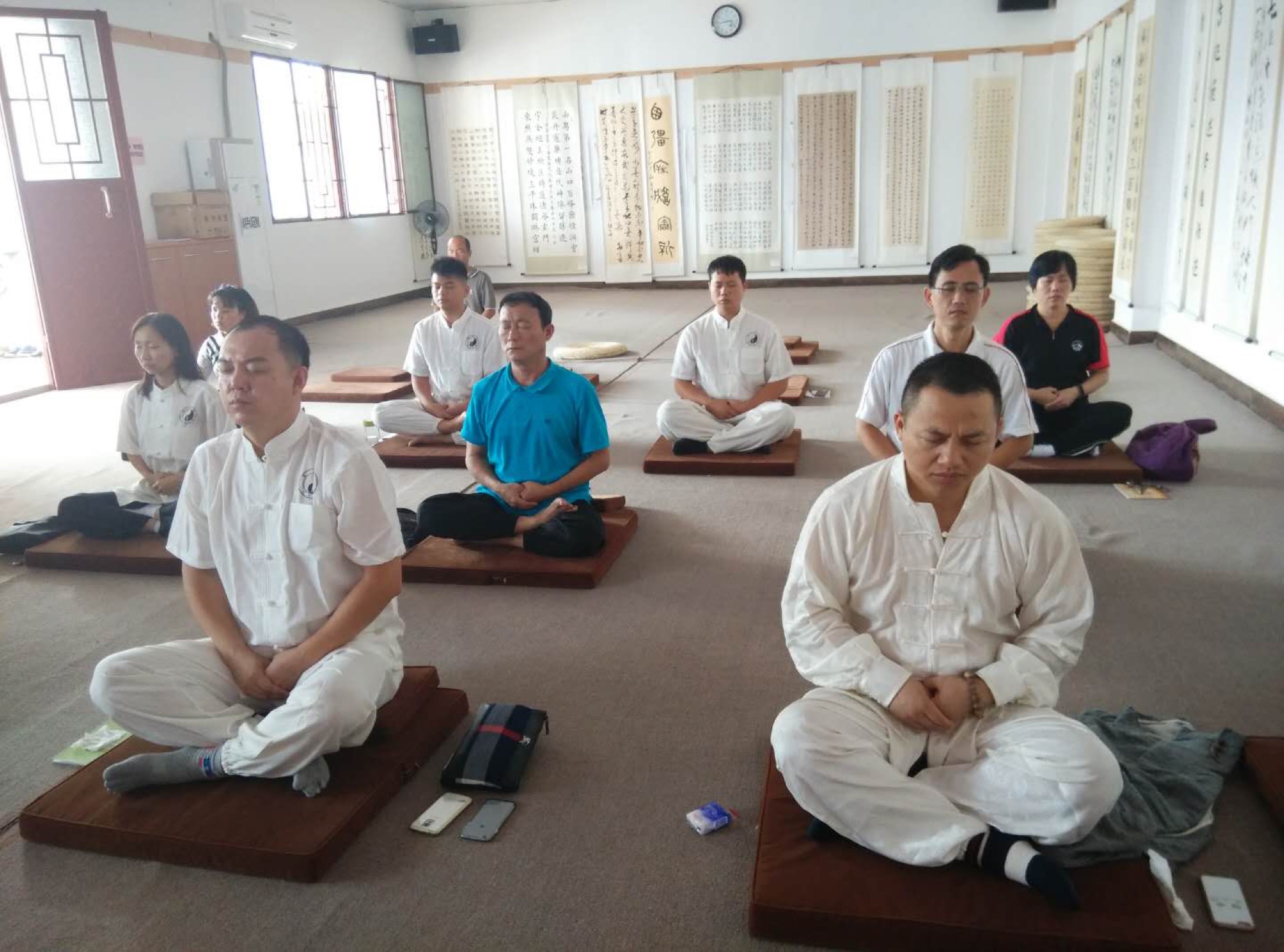 A group seated for a quiet practice session